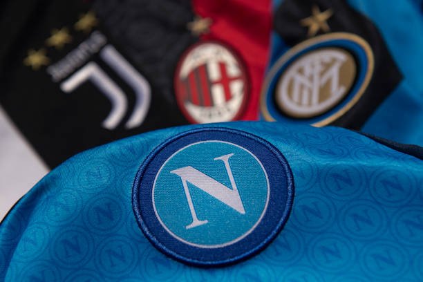 The official SSC Napoli FC club badge on a home shirt with the badges of Juventus, AC Milan and Inter Milan on May 3, 2023 in Manchester, United...